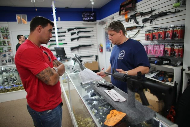 Customer Gun Shop AR-15 Customer looking at AR-15 in gun store